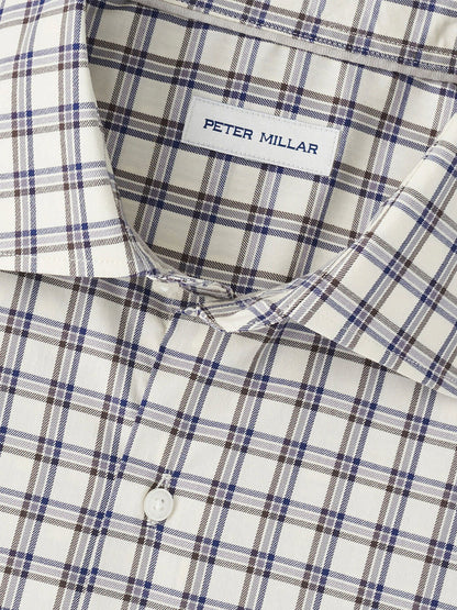Close-up of the Peter Millar Lenox Crown Lite Cotton-Stretch Sport Shirt in Winter Ivory featuring a beige, blue, and brown plaid pattern with white buttons and made from easy-care cotton-stretch fabric.