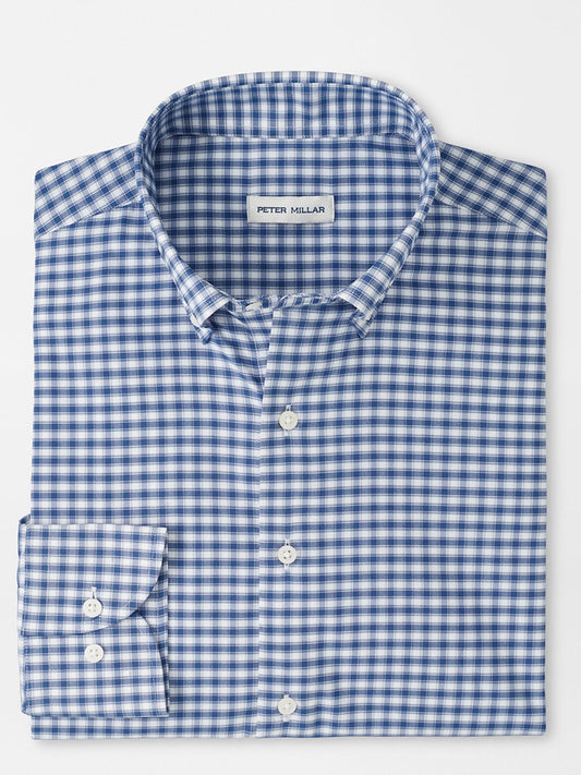 A folded Peter Millar Lewis Performance Twill Sport Shirt in Windsor Blue, featuring a blue and white checkered pattern and a visible label inside the collar.