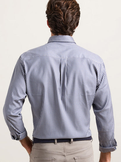 Back view of a man wearing a Peter Millar Liam Crown Soft Twill Sport Shirt in Navy with light-colored trousers.