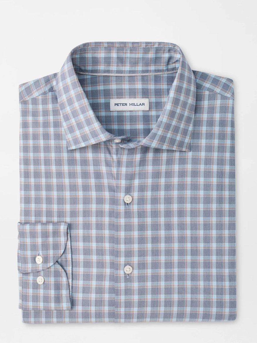 The Peter Millar Lincoln Crown Lite Cotton-Stretch Sport Shirt in Navy is a folded, long-sleeve button-up shirt showcasing a classic blue, white, and brown checkered pattern with the signature Peter Millar label visible. Designed in a classic fit from easy-care twill fabric with added stretch, this shirt delivers timeless style alongside lasting comfort.