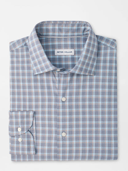 The Peter Millar Lincoln Crown Lite Cotton-Stretch Sport Shirt in Navy is a folded, long-sleeve button-up shirt showcasing a classic blue, white, and brown checkered pattern with the signature Peter Millar label visible. Designed in a classic fit from easy-care twill fabric with added stretch, this shirt delivers timeless style alongside lasting comfort.