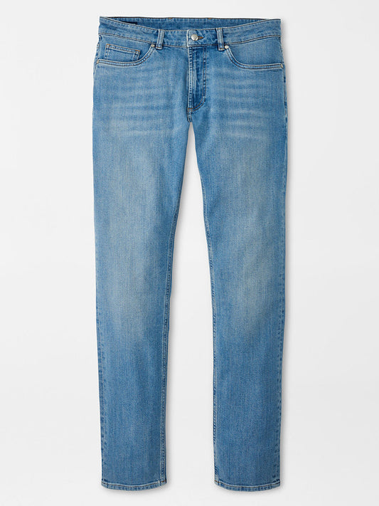 A pair of Peter Millar Vintage Washed Five-Pocket Denim in Stone Washed Blue jeans displayed against a white background.