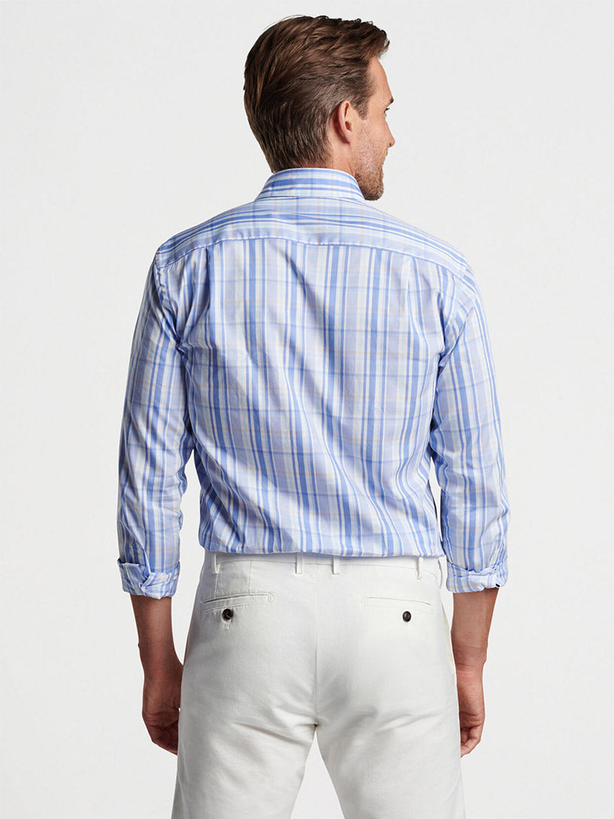 Man viewed from behind wearing a Peter Millar Marcel Cotton Sport Shirt in Cascade Blue and light-colored pants.