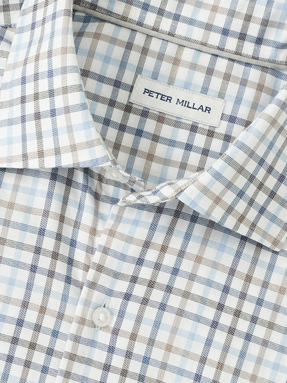 Close-up of the Peter Millar North Coast Crown Lite Cotton-Stretch Sport Shirt in Blue Haze, showcasing a blue, brown, and white plaid pattern, easy-care fabric, and the visible "Peter Millar" label.