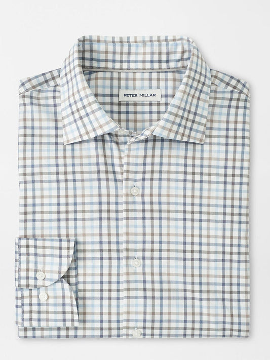 A folded Peter Millar North Coast Crown Lite Cotton-Stretch Sport Shirt in Blue Haze features a blue, gray, and beige plaid. Made from easy-care twill with a classic fit, it includes the "Peter Millar" label inside.