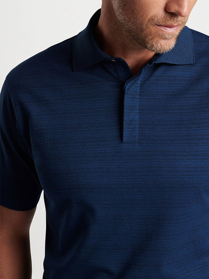 Close-up of a man wearing a Peter Millar Pembroke Polo in Blue Pearl, focusing on the shirt's texture and collar details.