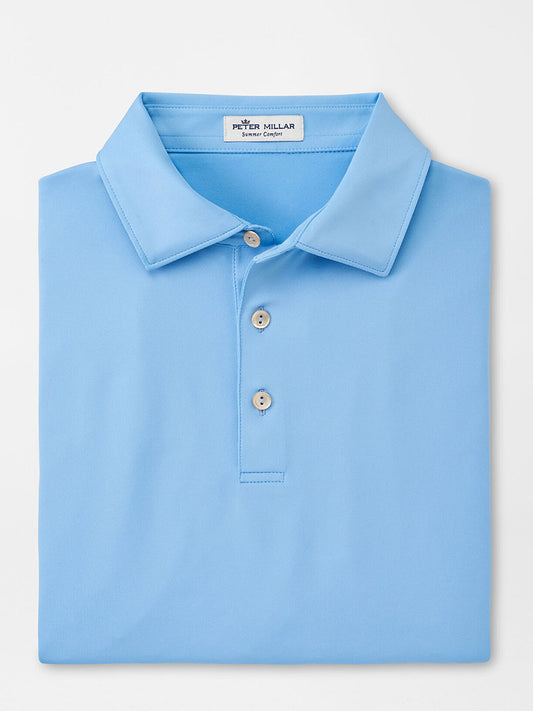 Light blue Peter Millar Solid Performance Jersey polo shirt neatly folded with a view of the collar and top buttons, perfect for the golf course.