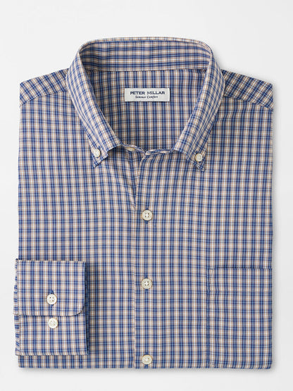 The Peter Millar Prairie Performance Twill Sport Shirt in Galaxy is a folded button-down shirt with a blue and orange plaid pattern, featuring a chest pocket, long sleeves, and easy-care performance fabric.