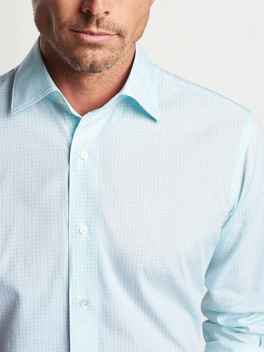 Man in a Peter Millar Renato Cotton Sport Shirt in Iced Aqua with top buttons unfastened.