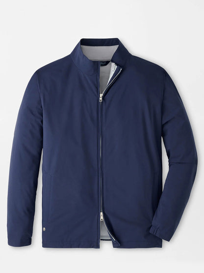 The Peter Millar Ryder 3-in-1 Jacket in Navy is a zip-up lightweight performance shell with a stand collar and long sleeves, featuring a minimalist design. Displayed against a plain white background.