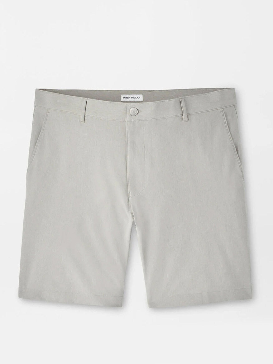 The Peter Millar Shackleford Performance Hybrid Short in British Grey features belt loops, side pockets, a button closure, and is made from four-way stretch, water-resistant fabric. Pictured laid flat on a white background.