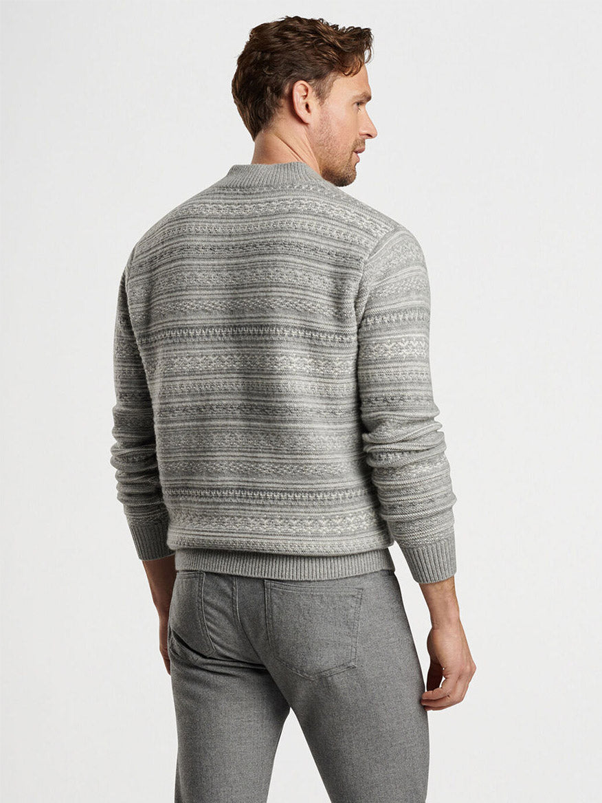 A person is wearing the Peter Millar Silverton Jacquard Quarter-Zip in Gale Grey along with gray pants, standing with their back to the camera.