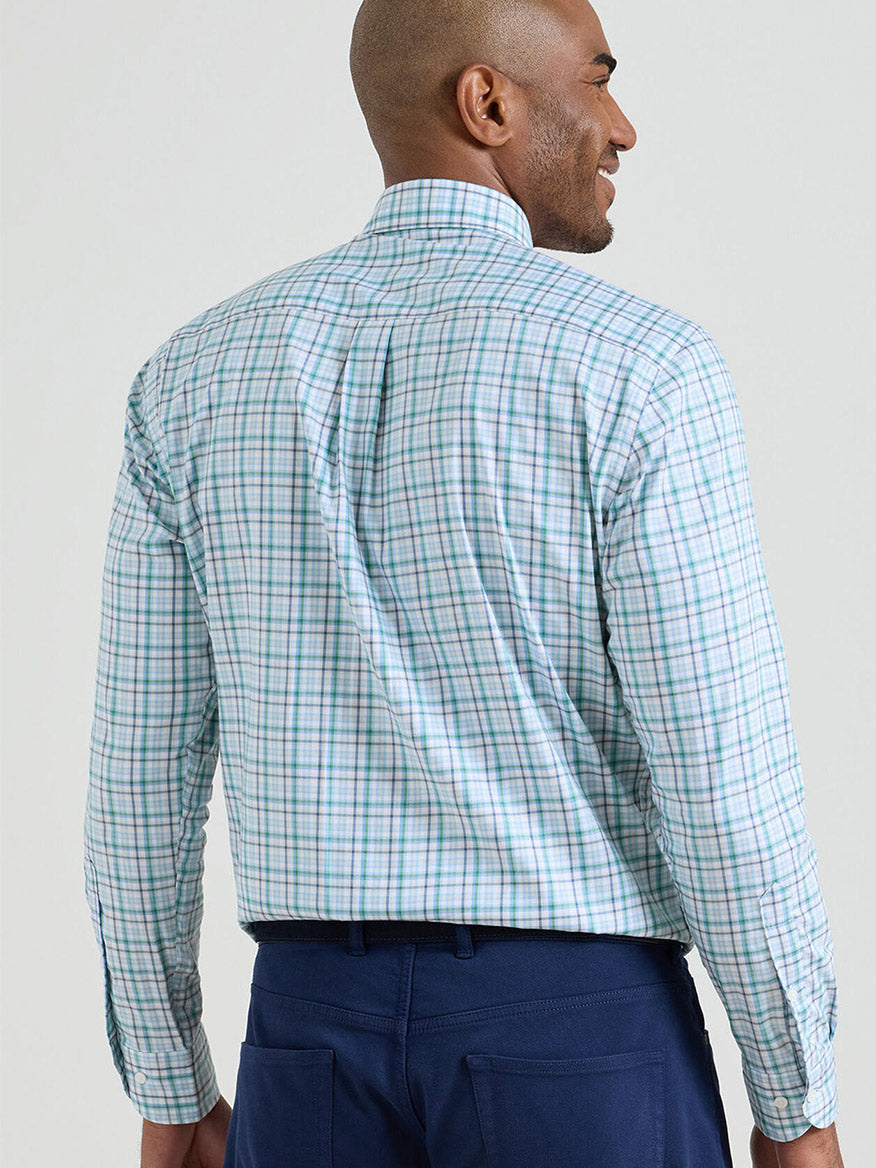 A man seen from the back wearing a Peter Millar Simon Crown Lite Cotton-Stretch Sport Shirt in Windsor Blue and dark blue pants.