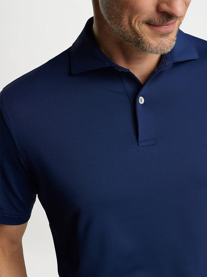 Man wearing a Navy Peter Millar Solid Performance Jersey Polo.