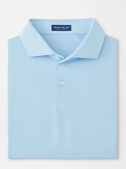 The Peter Millar Soul Performance Mesh Polo in Blue Frost is a light blue, collared shirt with two buttons, made from breathable wicking mesh fabric and featuring a "Peter Millar" label inside the neck.