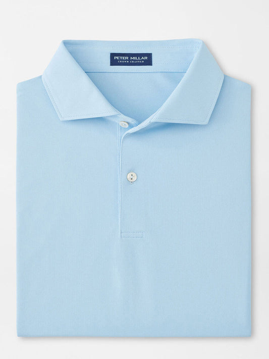 The Peter Millar Soul Performance Mesh Polo in Blue Frost is a light blue, collared shirt with two buttons, made from breathable wicking mesh fabric and featuring a "Peter Millar" label inside the neck.