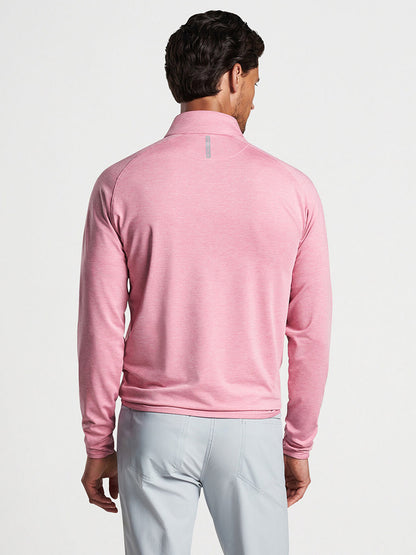 Man wearing a Spring Blossom Peter Millar Stealth Performance Quarter-Zip and grey trousers viewed from the back.