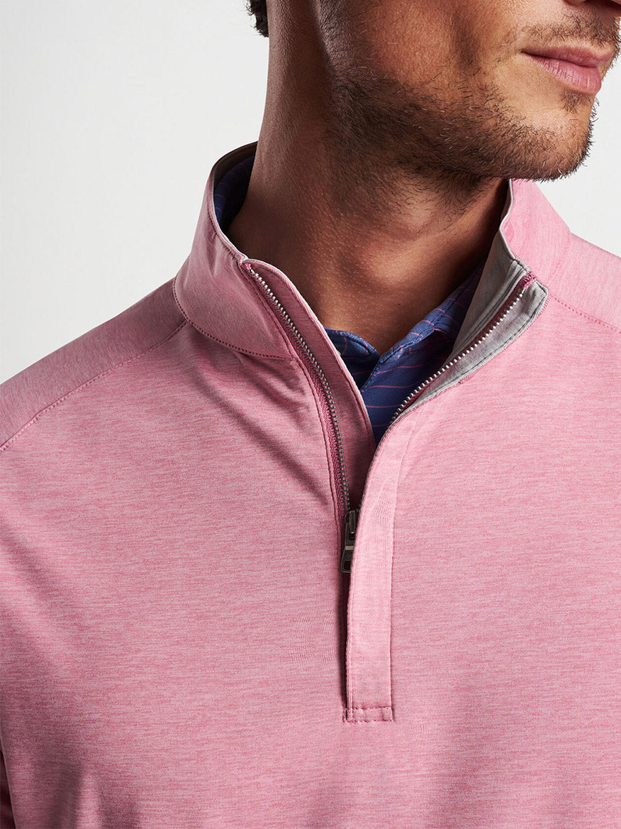 Man wearing a Peter Millar Stealth Performance Quarter-Zip in Spring Blossom with UPF 50+ sun protection over a patterned collar shirt.