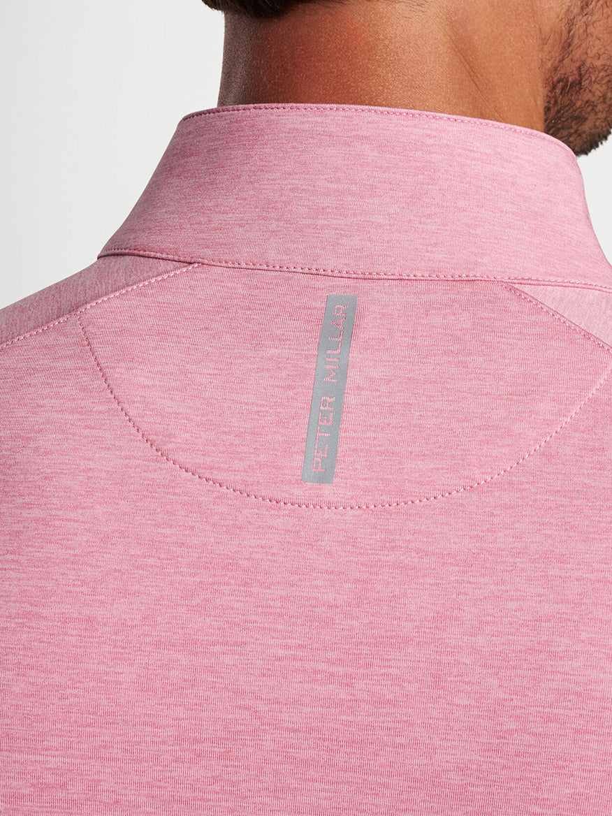 Close-up of a Peter Millar Stealth Performance Quarter-Zip in Spring Blossom's pink back collar with a branded label.