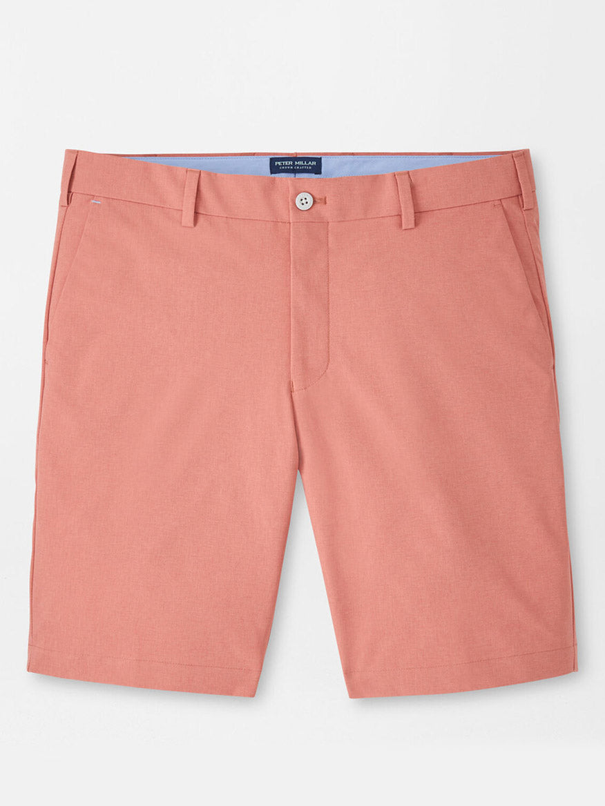 The Peter Millar Surge Performance Short in Faded Scarlet is a pair of four-way stretch tailored shorts with belt loops, button closure, and side pockets, shown laid flat on a white background.