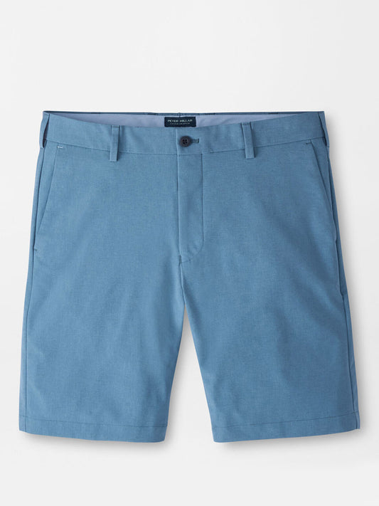 The Peter Millar Surge Performance Short in Storm, featuring water-resistant blue fabric, belt loops, button closure, side pockets, and a tailored fit, is displayed flat against a white background.