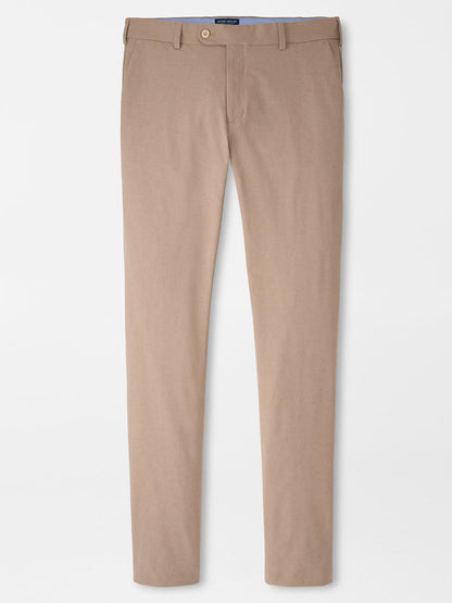 The Peter Millar Surge Performance Trouser in Biscotti features a slim fit, water-resistant design with belt loops, button closure, and side pockets—combining style and functionality against a plain white background.