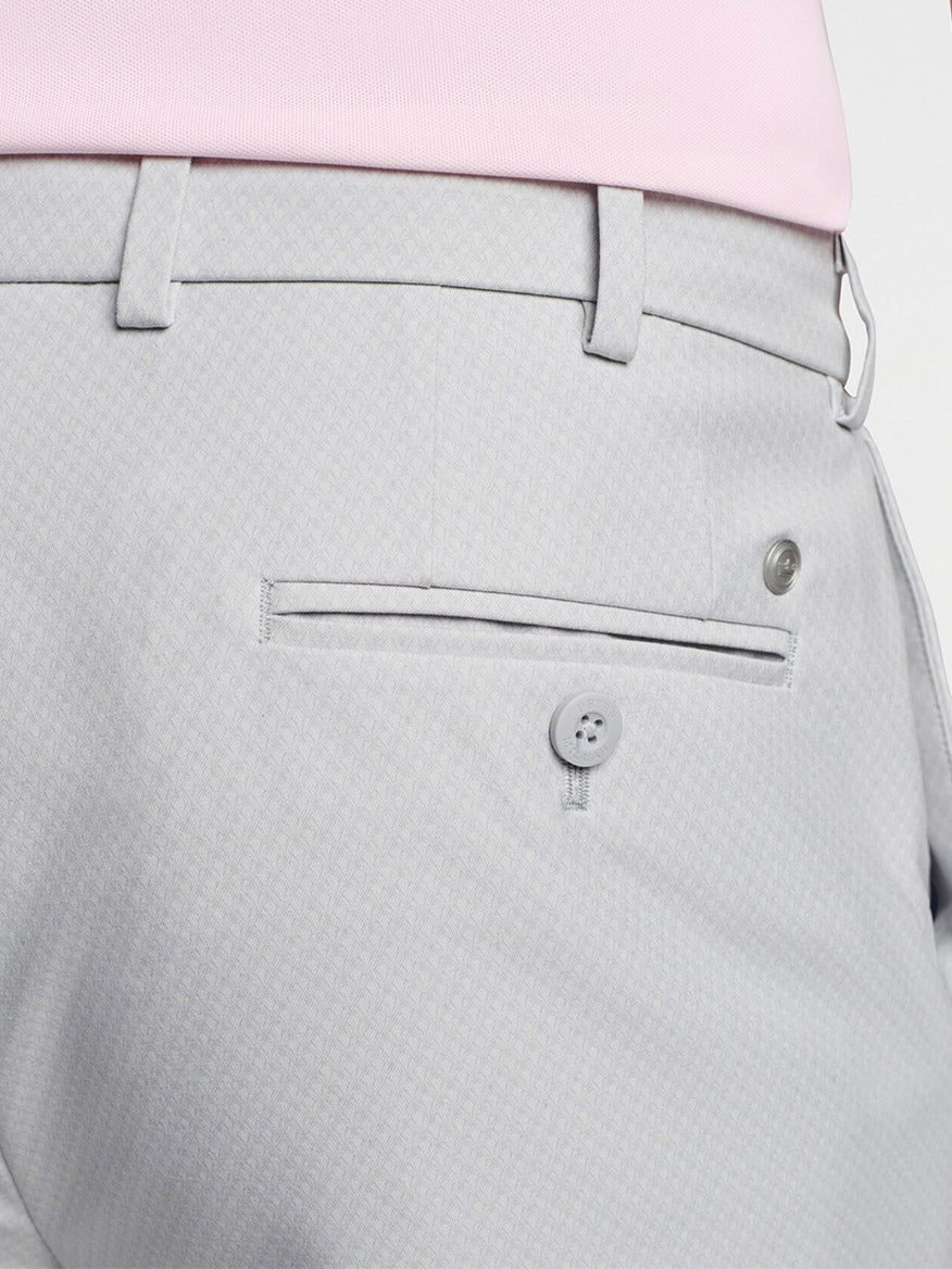 Close up of Peter Millar Surge Signature Performance Short in British Grey, water-resistant trousers with a pocket and button detail.
