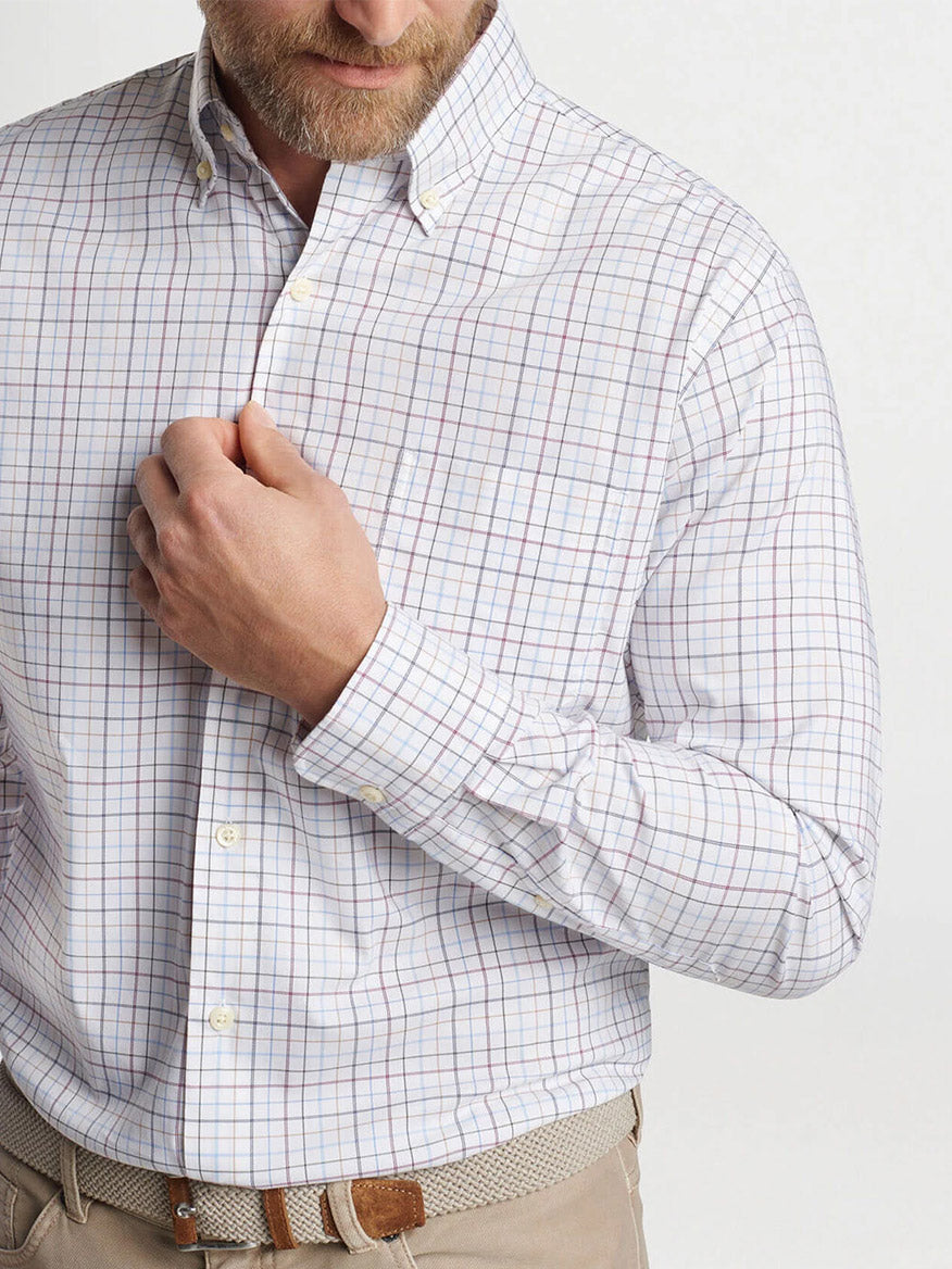 A man in a Peter Millar Sydney Crown Lite Cotton-Stretch Sport Shirt in White adjusts his collar, partially facing the camera.