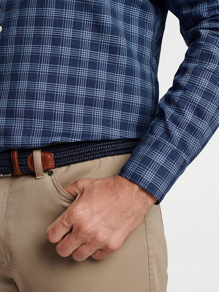 A person wearing the Peter Millar Thompson Summer Soft Cotton Sport Shirt in Galaxy, neatly tucked into khaki cotton twill pants, with a brown belt. The right hand is casually resting in the pants pocket.