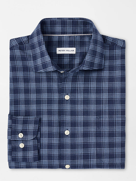 The Peter Millar Thompson Summer Soft Cotton Sport Shirt in Galaxy is a folded navy blue plaid shirt with light blue stripes, made from cotton twill. It features buttoned cuffs, a visible label on a white background, and offers a classic fit.