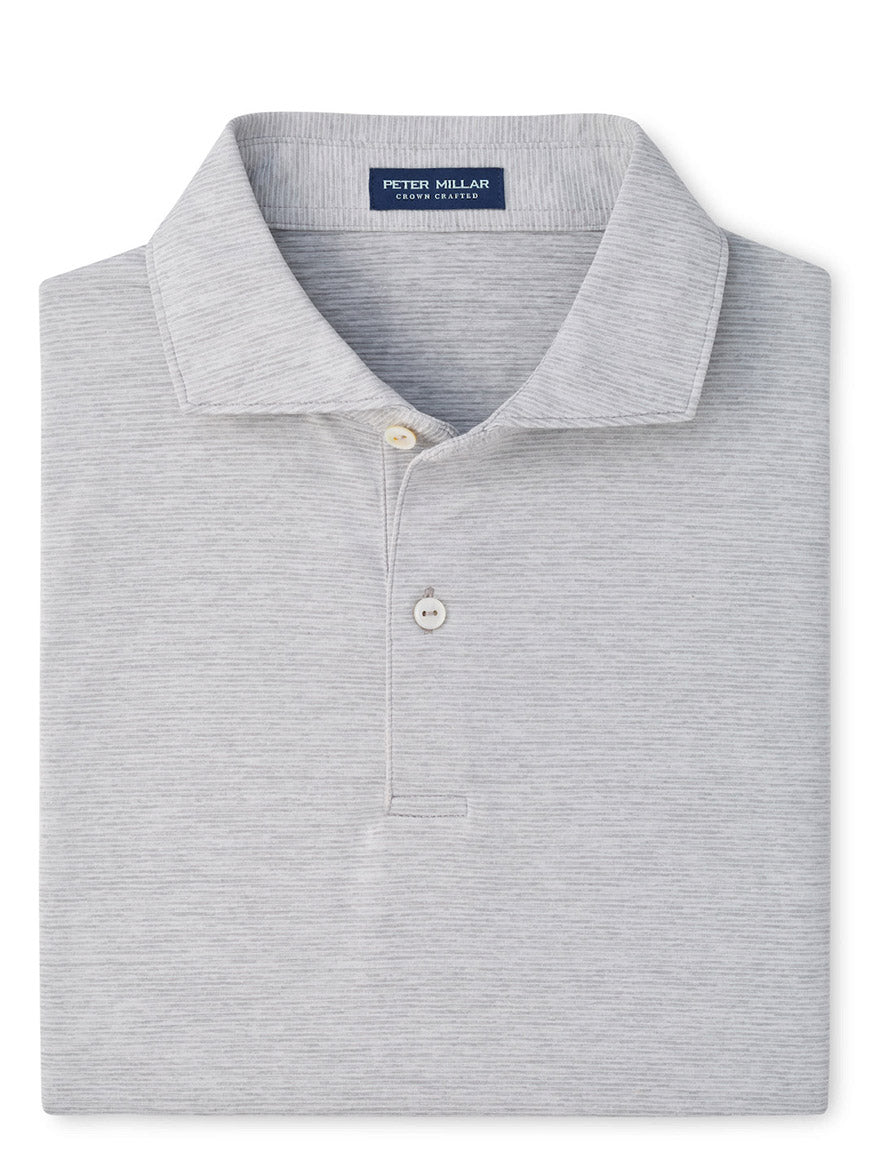 A neatly folded Peter Millar Treble Performance Jersey Polo Edwin Spread Collar in Gale Grey, featuring two buttons and four-way stretch for ultimate comfort.