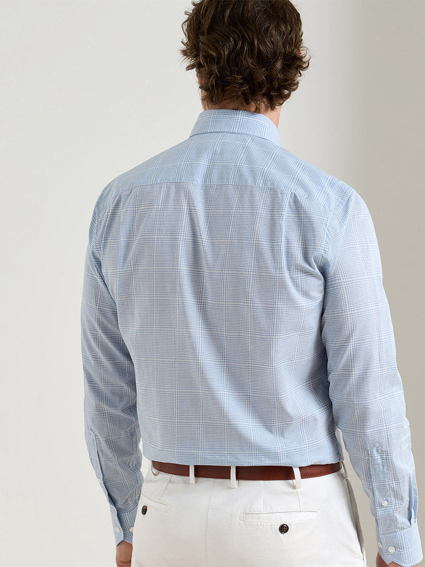 A man is shown from the back wearing the Peter Millar Urbino Italian Poplin Sport Shirt in Iris Mist with white pants.