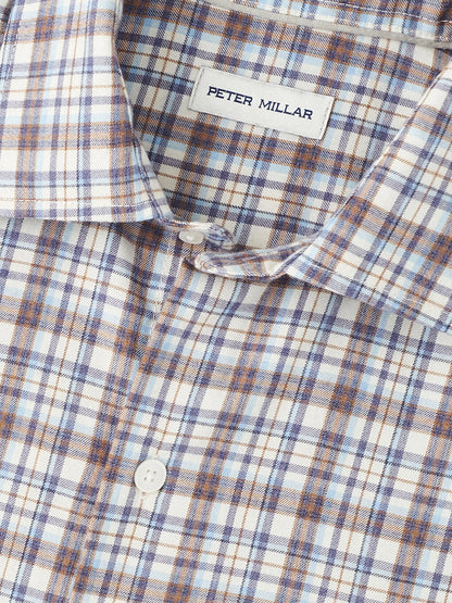 A close-up of the Peter Millar Waynesville Performance Flannel Sport Shirt in Winter Ivory, showcasing a blue, brown, and white plaid pattern made from soft performance fibers—your ideal go-to for fall.
