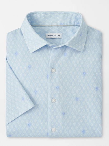 The Peter Millar Whitehaven Cotton Lyocell Sport Shirt in Stream Blue is a classic-fit, stretch performance shirt featuring a light blue hue and subtle white and blue geometric pattern, neatly folded.