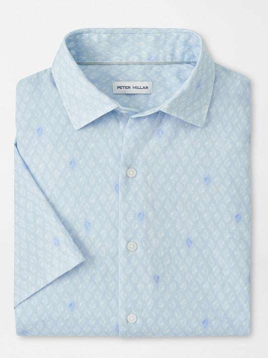 The Peter Millar Whitehaven Cotton Lyocell Sport Shirt in Stream Blue is a classic-fit, stretch performance shirt featuring a light blue hue and subtle white and blue geometric pattern, neatly folded.