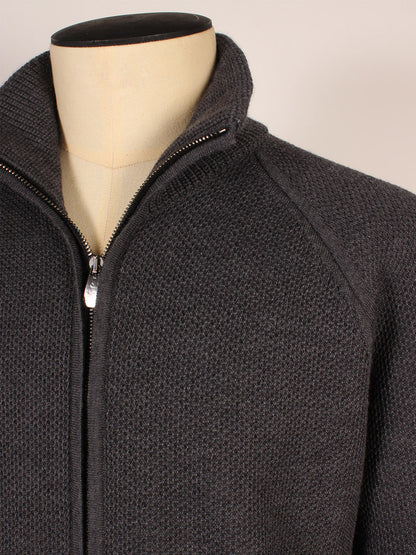 Close-up of a mannequin wearing the Piacenza 1733 Birdseye Zip Bomber in Charcoal, featuring textured knit fabric, raglan sleeves, and a standing collar.