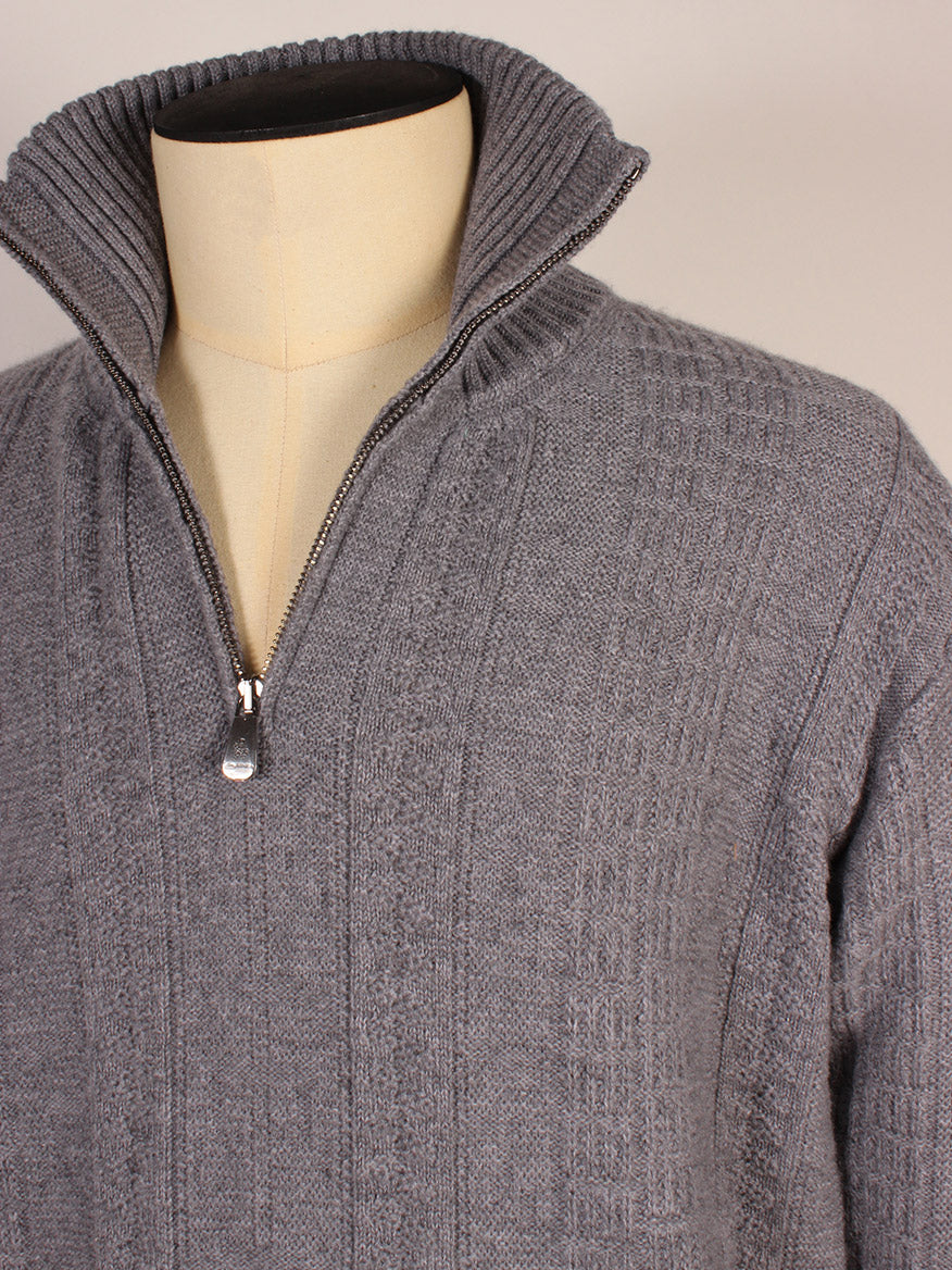 The Piacenza 1733 Cashmere Mock Neck Quarter Zip Sweater in Medium Grey is shown on a dress form, featuring a partially open zipper and a standing collar.