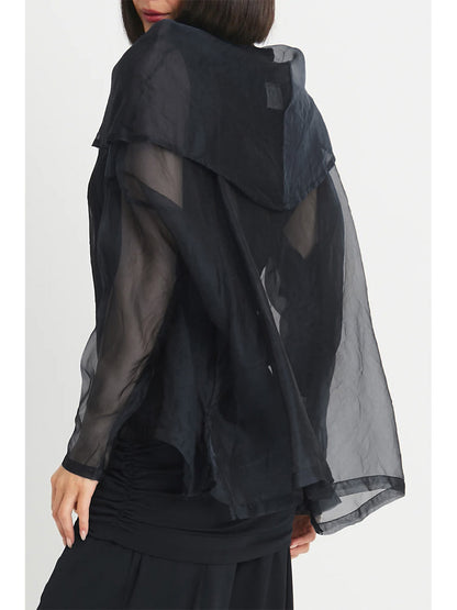 A person is shown from the side and back, wearing the Planet by Lauren G Organza Cowl Neck Top in Black—a semi-transparent, loose-fitting garment with long sleeves and a layered design that adds a feminine touch.