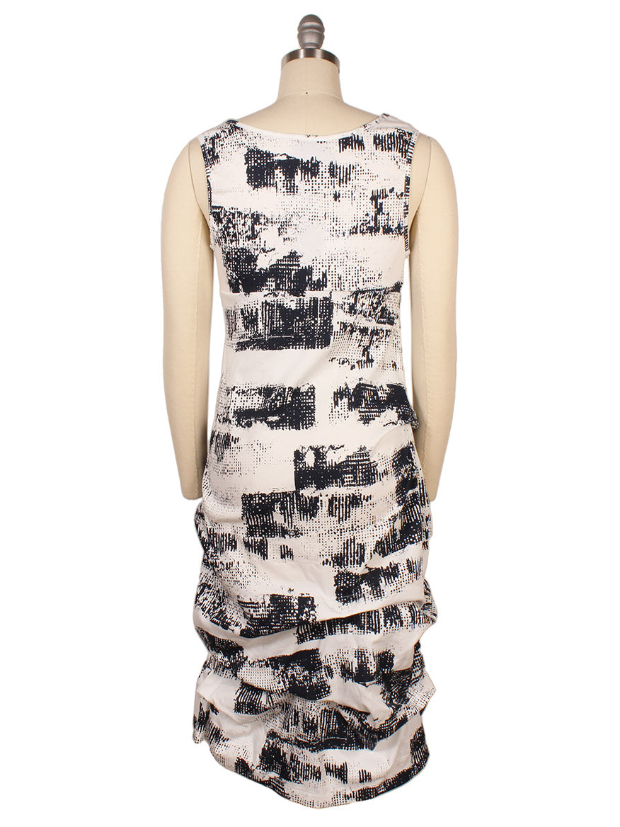 Back view of a sleeveless Porto Casbah Dress in Naples Spumante on a mannequin, featuring a black and white abstract print with gathered detailing at the skirt, crafted from lightweight woven fabric for a modern design.