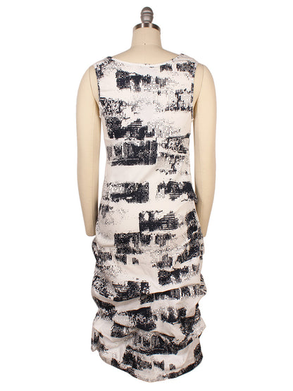 Back view of a sleeveless Porto Casbah Dress in Naples Spumante on a mannequin, featuring a black and white abstract print with gathered detailing at the skirt, crafted from lightweight woven fabric for a modern design.