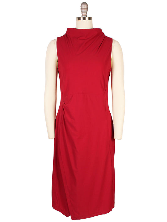 The Porto Nina Dress in Garnet, crafted in Italy, features a draped neckline and subtle side ruching on a knee-length silhouette, elegantly shown on a mannequin.