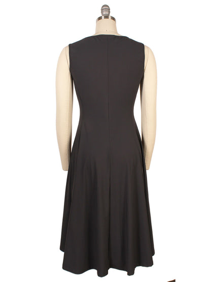 A sleeveless, knee-length Porto Olivia Dress in Smoke with elegant pintuck detail is displayed on a mannequin and shown from the back.