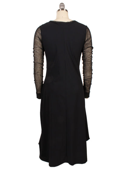 The Porto Venetian Dress in Black is a knee-length, fitted dress with mesh long sleeves, shown from the back on a dress form. Made in Italy.