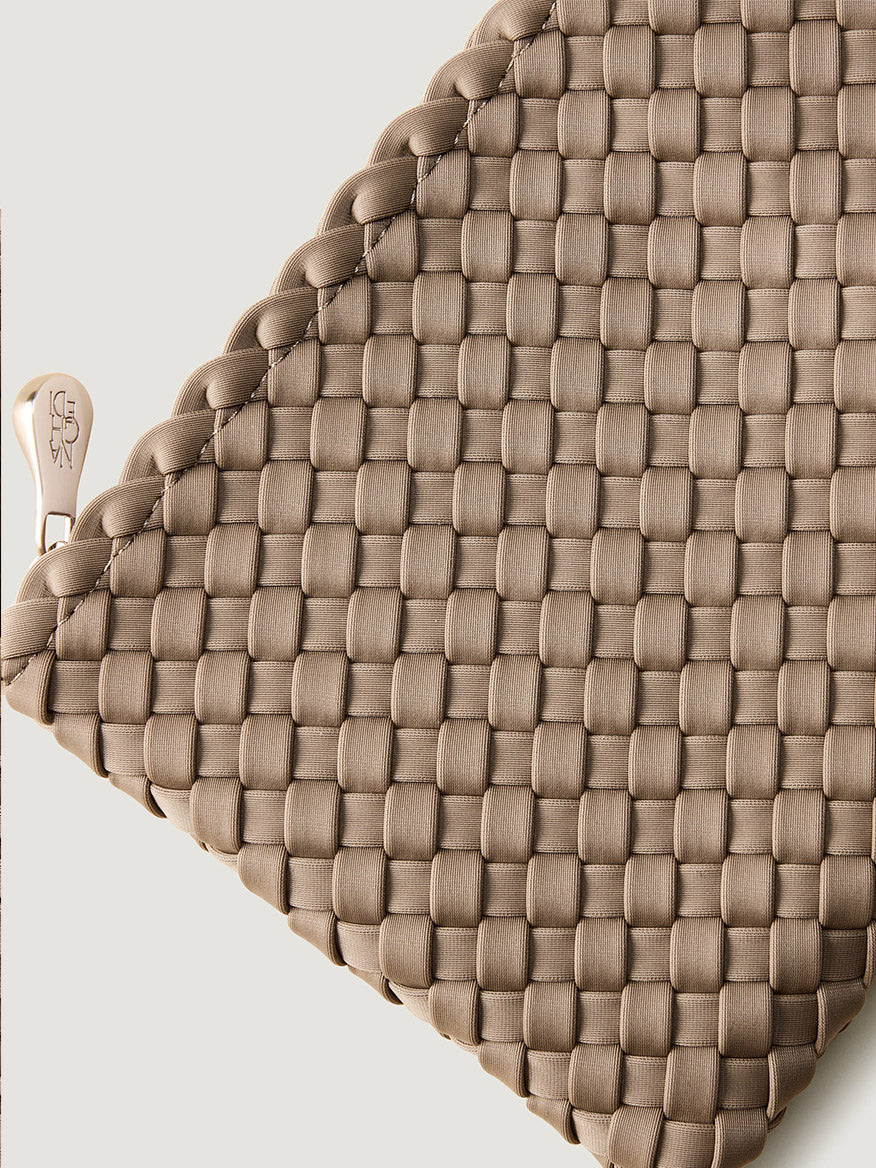 Close-up of a tan handwoven Naghedi Mercer Large Bucket in Cashmere with a metallic zipper pull.