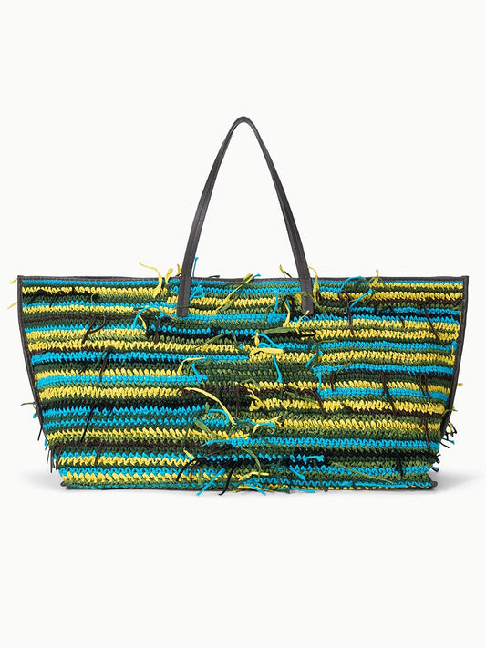 The STAUD Christos Large Tote in Happy Sack features black handles, horizontal blue, yellow, and green stripes with frayed yarn accents—a vibrant handcrafted bag perfect for daily use.