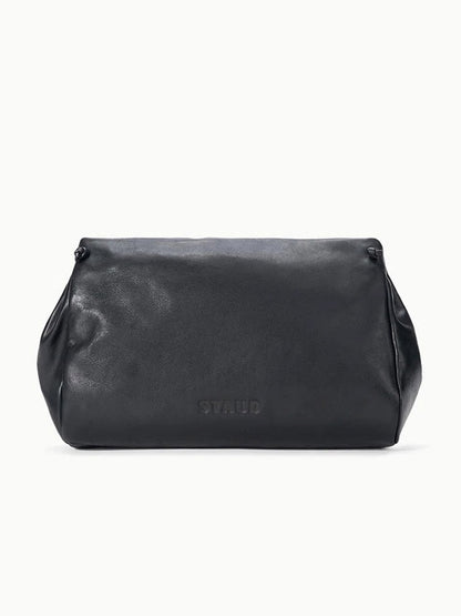 STAUD Cy Convertible Bag in black leather with a rounded, fold-over silhouette and a debossed logo on the front.