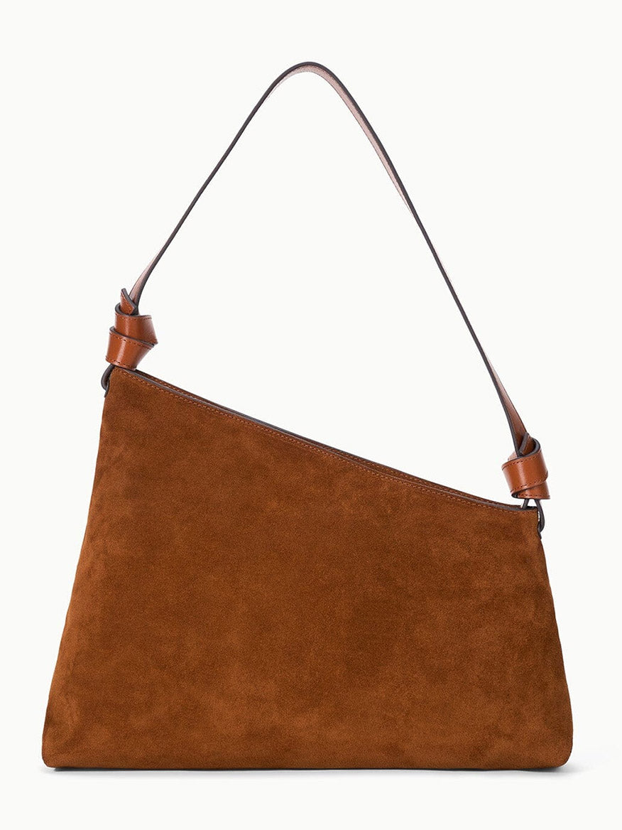 STAUD Dani Shoulder Bag in Tabac, crafted from brown suede with an asymmetrical silhouette and a single knotted strap, displayed against a plain white background.