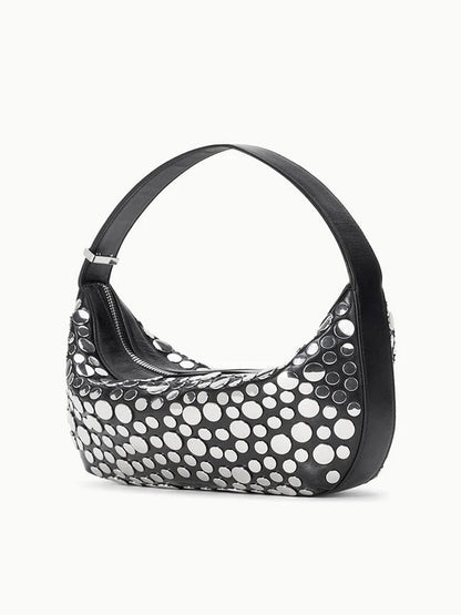 The STAUD Demy Shoulder Bag in Rivets showcases a curved silhouette in smooth nappa leather with shiny silver circular studs accenting the front and sides.