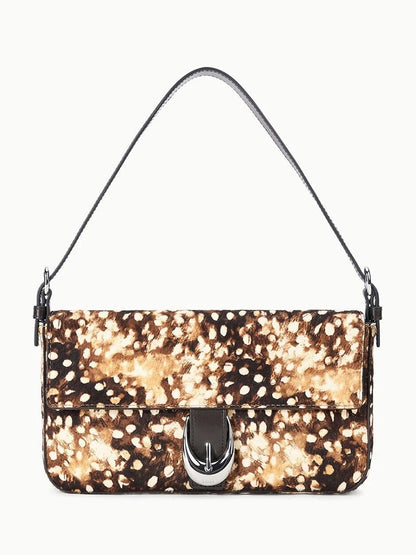 STAUD Harlow Bag in Fawn Haircalf, a rectangular bag in brown and white spotted haircalf with a dark brown leather handle and silver buckle closure on the front flap.