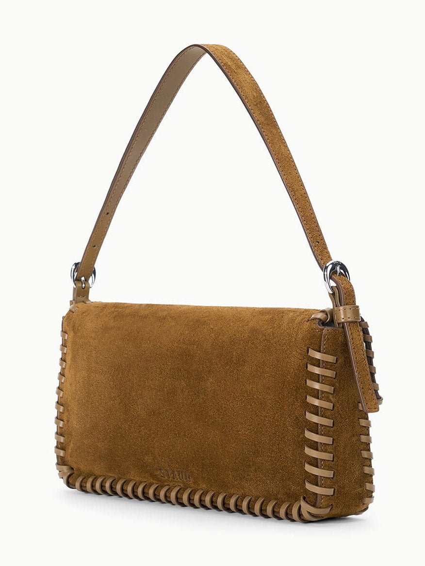 STAUD Harlow Bag in Cigar, a brown suede shoulder bag featuring whipstitch detailing and a buckle-adjustable strap.